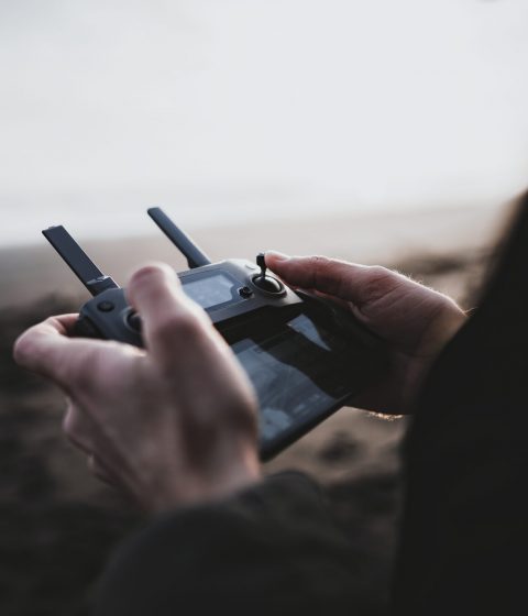 Man controlling a drone by a remote control