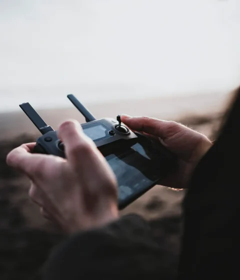 Man controlling a drone by a remote control